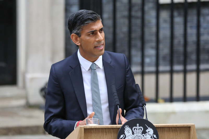 A man speaks from a lectern