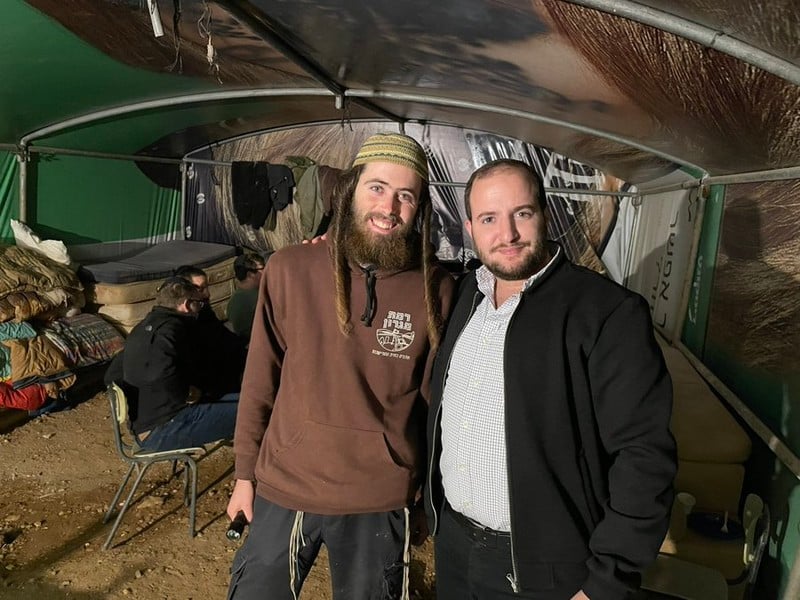 Elisha Yered and Yossi Levi stand inside a structure