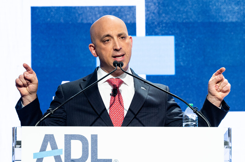 Jonathan Greenblatt of the ADL gesticulates from behind a podium at an ADL event