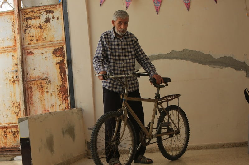A man stands with a bicycle