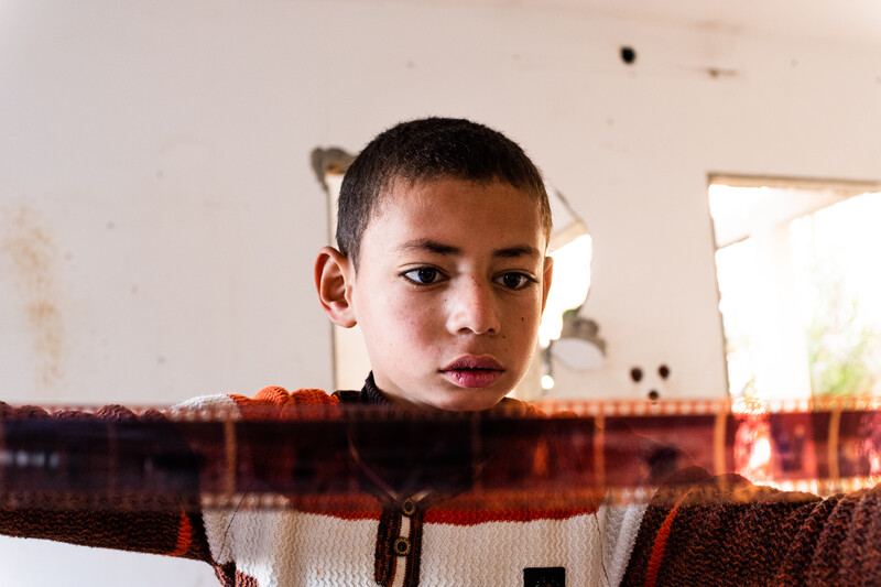 A boy looks at photo negatives