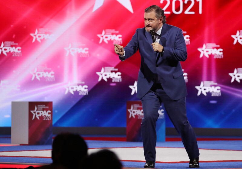 Ted Cruz leans forward and points finger on stage