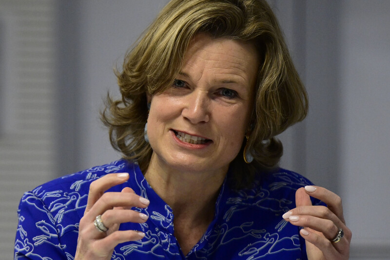 Shot of a woman from shoulders up gesticulating and speaking