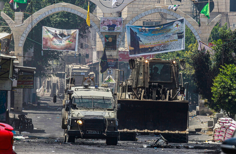 An Israeli military bulldozer and jeep in Jenin refugee camp