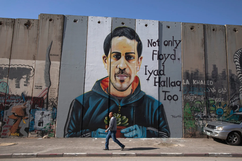 A mural of Iyad al-Hallaq above a misleading caption from The New York Times