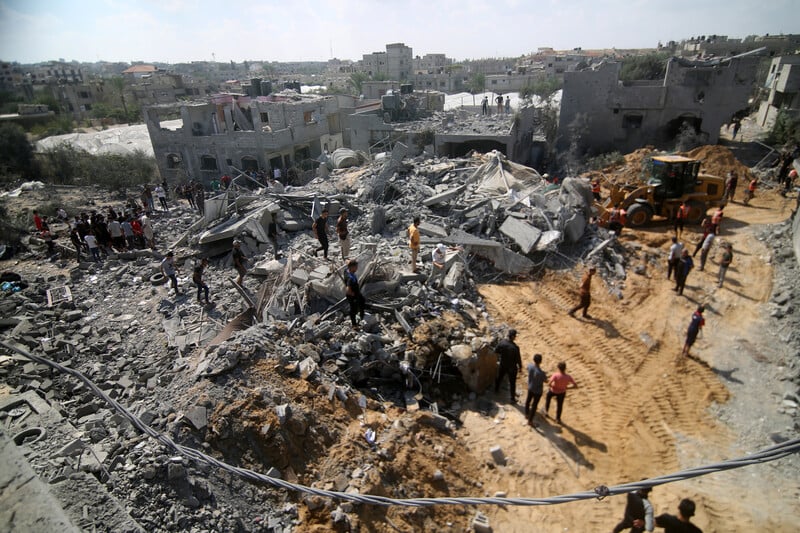 Aerial view of people standing on top of debris