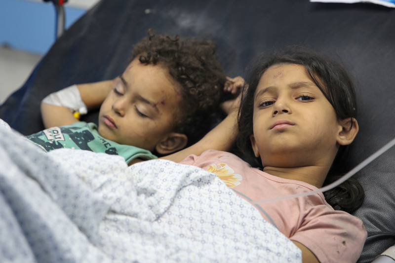 Injured boy and girl lay down side by side 