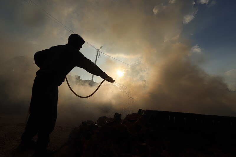 Silhouette of a man against a backdrop of smoke 