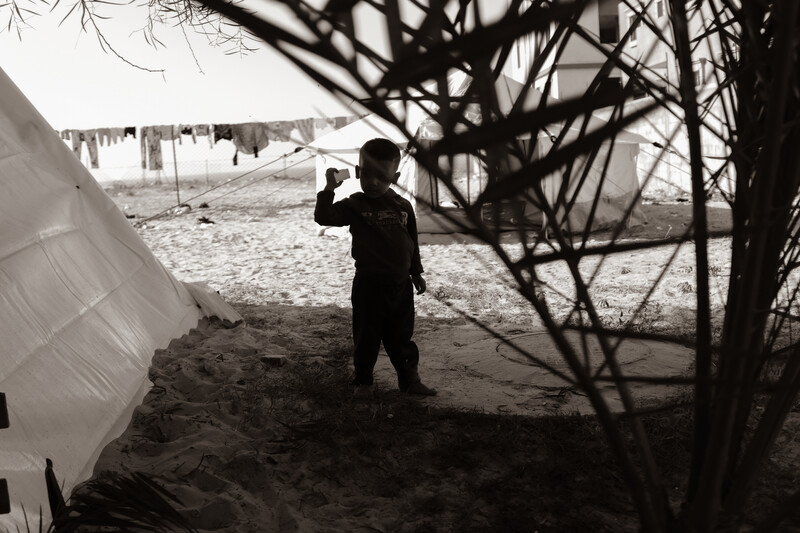 A boy holds up his hand