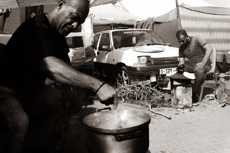 A man stirs a pot