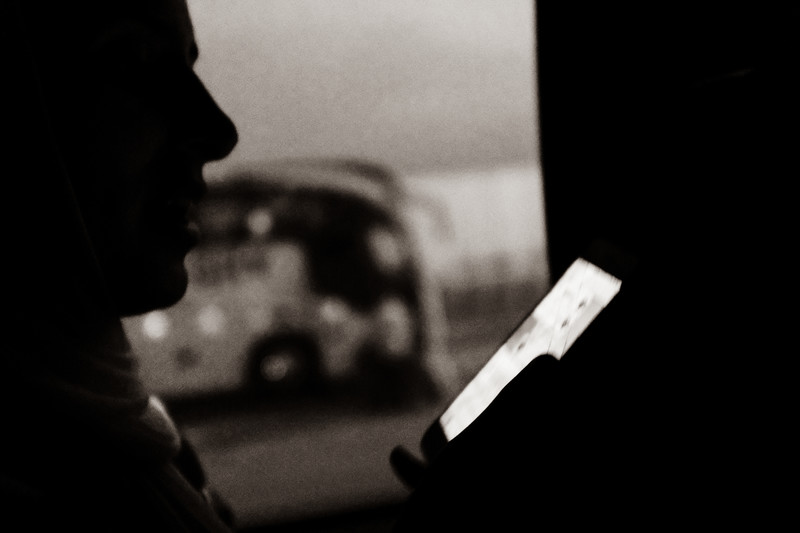 Silhouette of a person on their phone