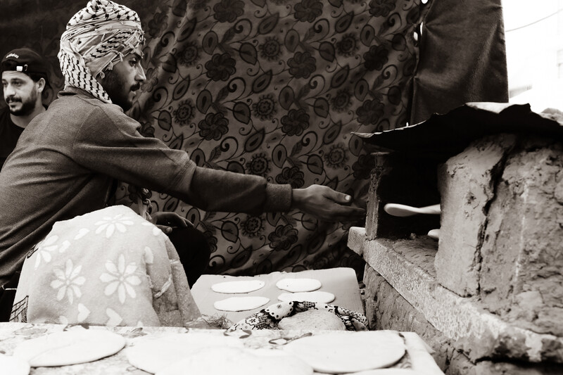 Man reaches for freshly baked bread