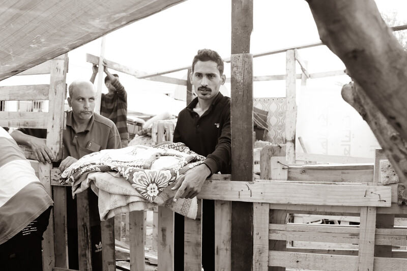 Two men wait for bread