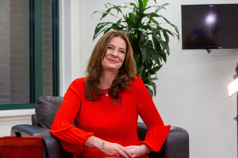 A woman in chair, smiling