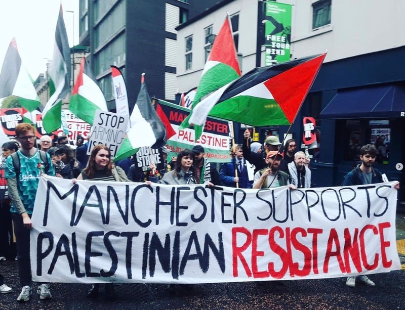 "Manchester Supports the Palestinian Resistance," a protest banner reads.