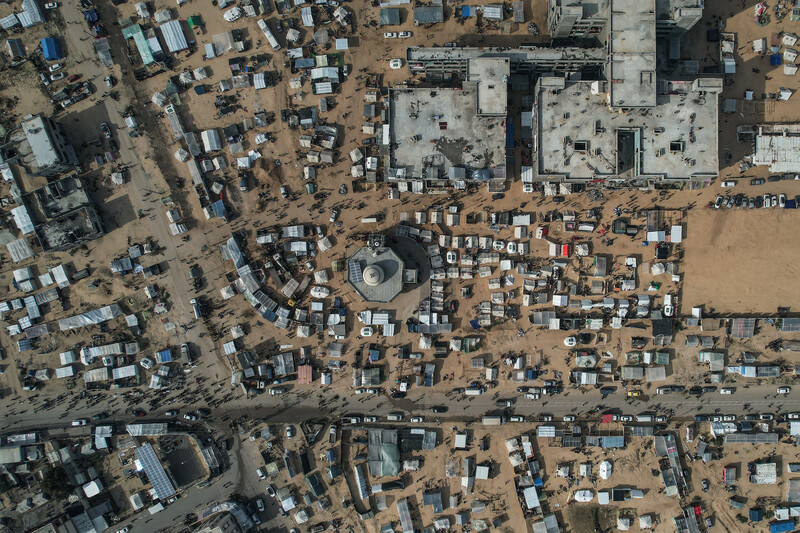 overhead of hundreds of people and makeshift tents dotting the entire frame