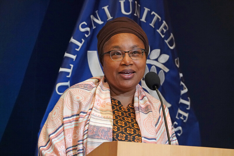 Alice Wairimu Nderitu stands at a podium with logo of U.S. Institute of Peace behind her