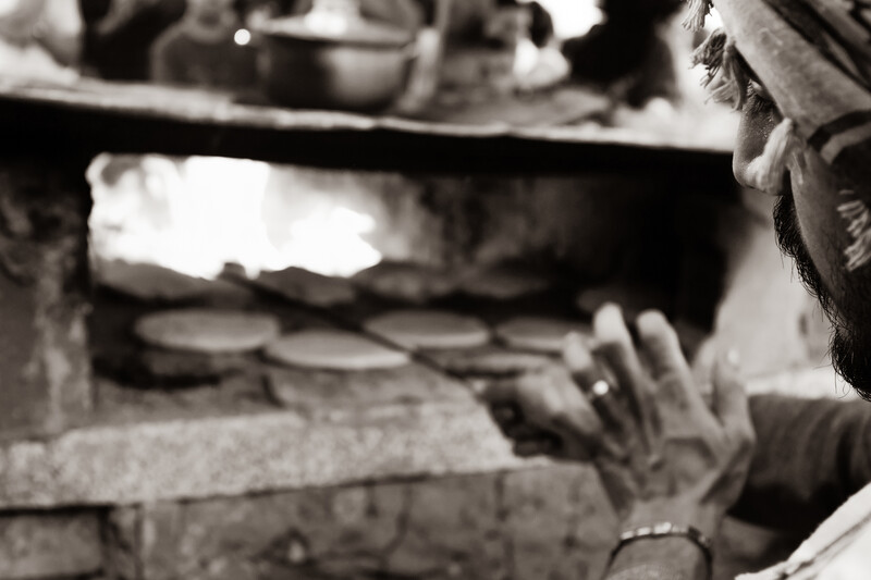 Bread is prepared in a makeshift oven.