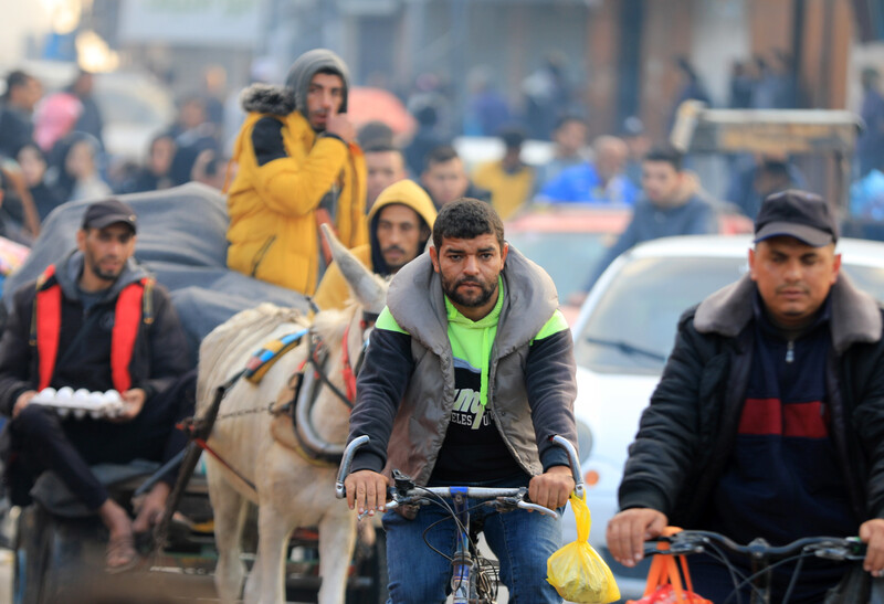 People on donkeys, walking, in cars