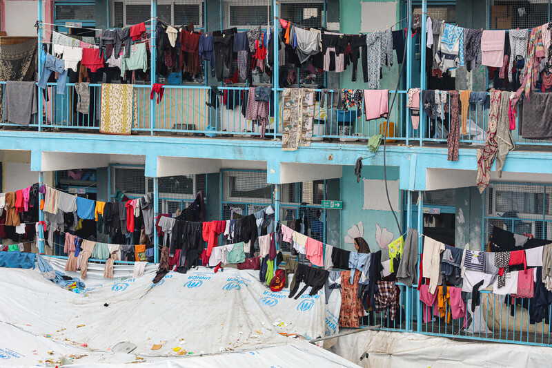 Tents and washing lines compete for space in a school