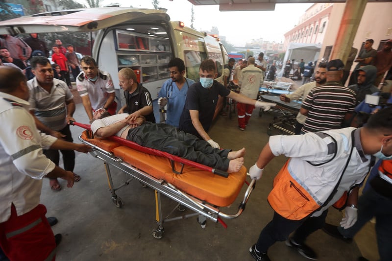 Paramedics bring an injured man to hospital