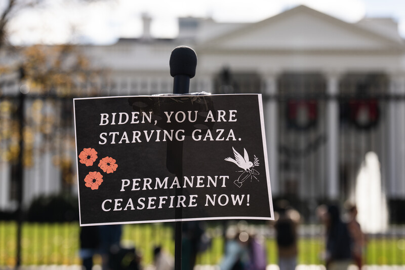 A sign in front of the White House accuses Joe Biden of starving Gaza