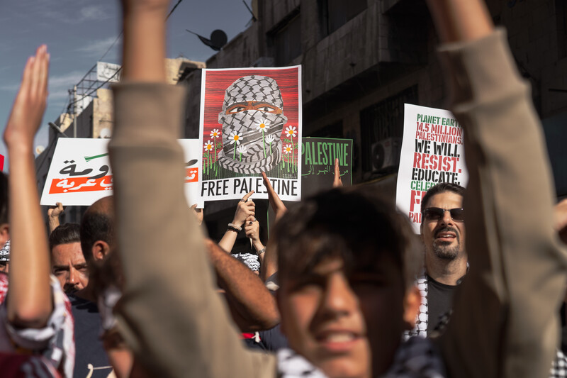 A placard with Abu Obeida's face at a demonstration