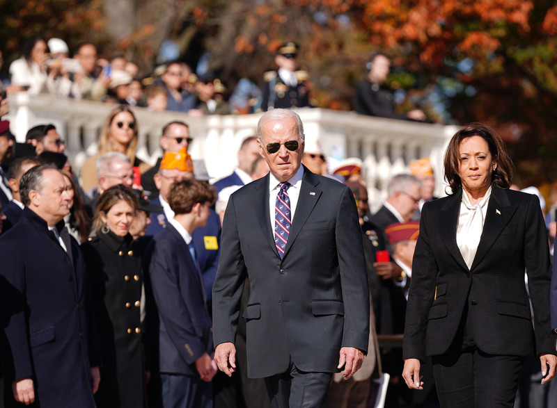 Joe Biden and Kamala Harris walk past a crowd
