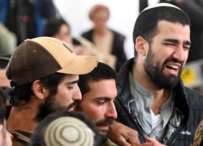 Close up of faces of three anguished young men