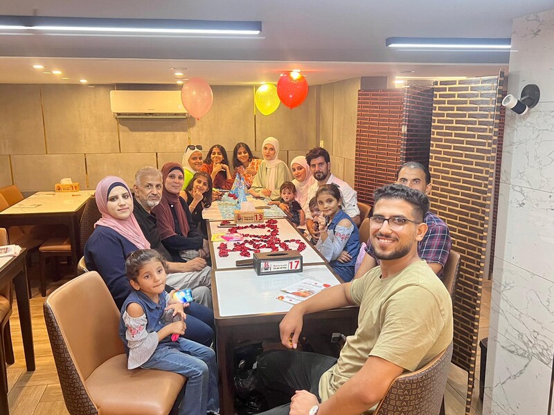 A family smiles around a table