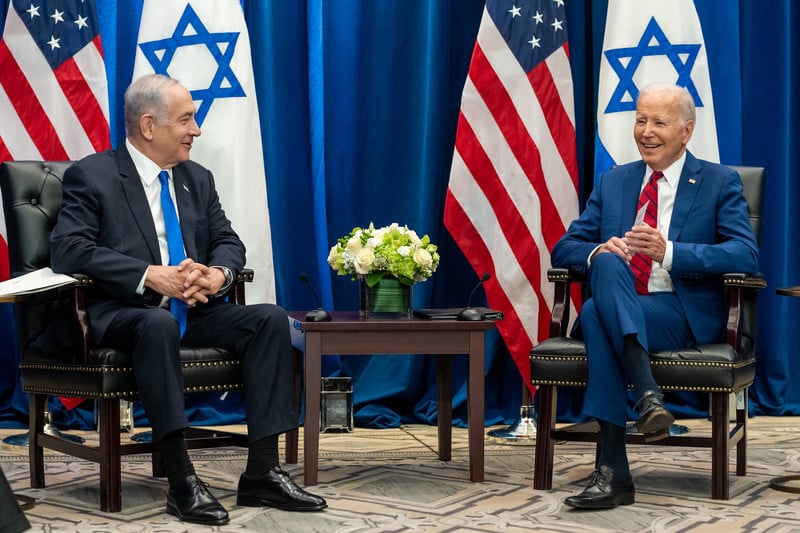 Benjamin Netanyahu and Joe Biden, seated, with US and Israeli flags behind them