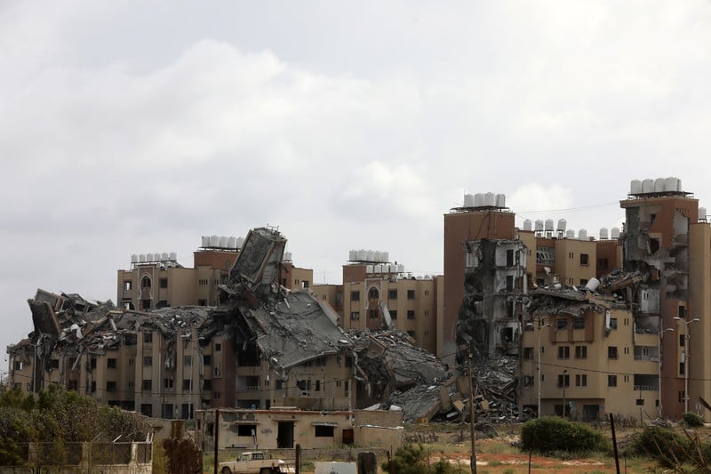A group of destroyed buildings against a cloudy sky