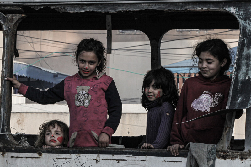 Four children play in the wreckage of a bus