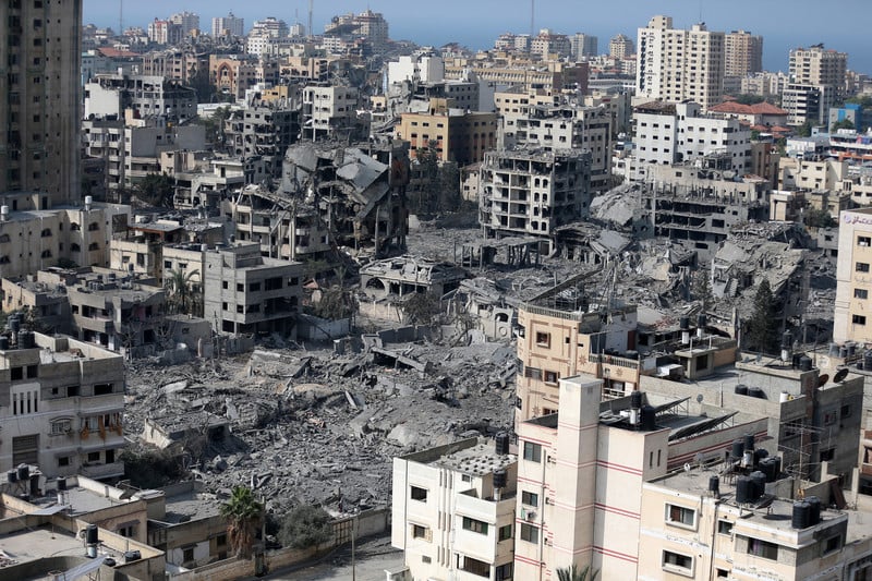 Aerial view of several blocks bombed to the ground in densely built-up area