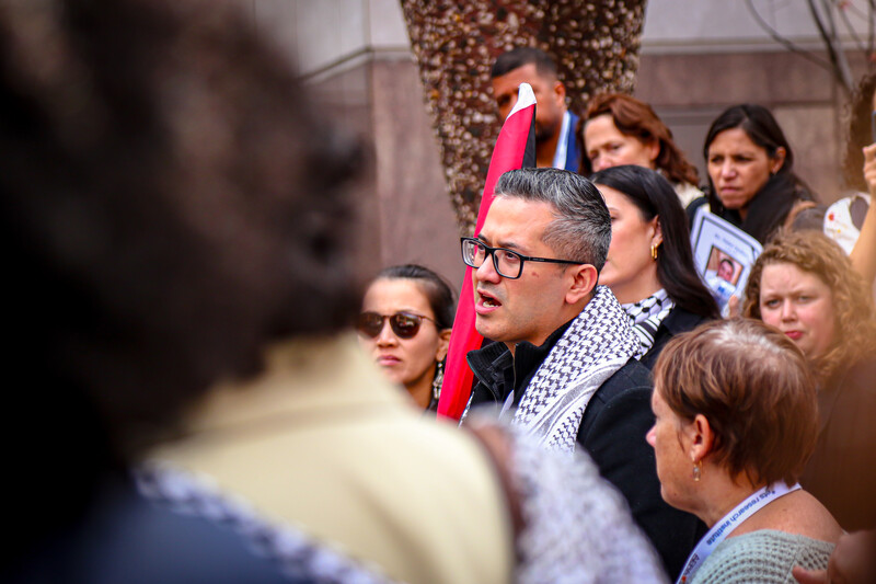 A man speaks in a crowd of people