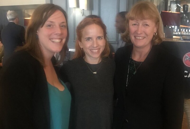 Three women pose for the camera