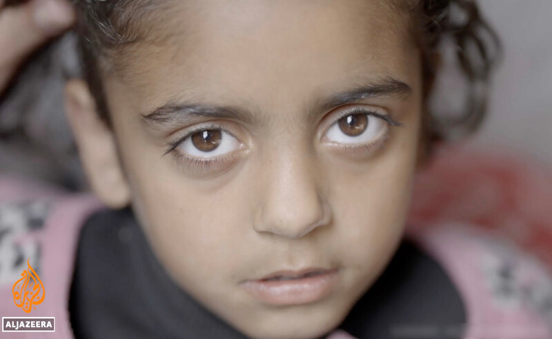 A Palestinian girl stares into the camera