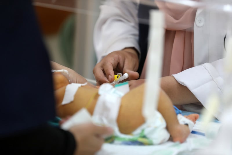 A premature baby receives treatment
