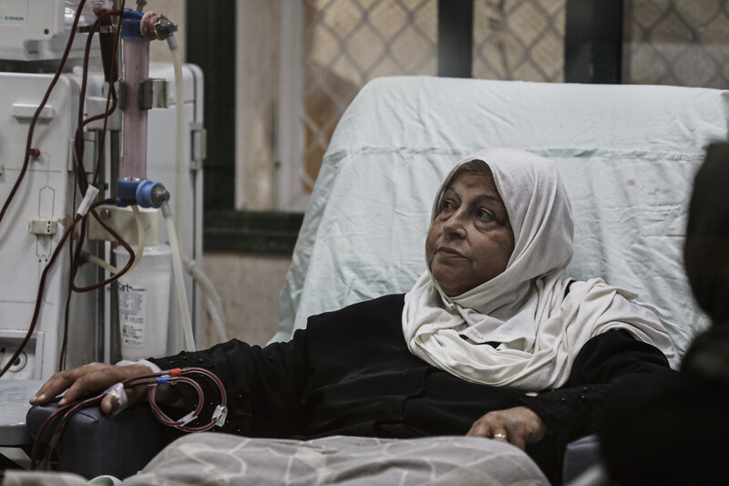 A woman receives treatment in a hospital bed