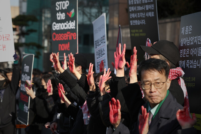 Protestors in Seoul hold up placards demanding an end to the genocide in Gaza