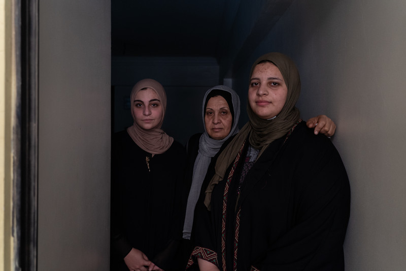 Three women stand in a doorway