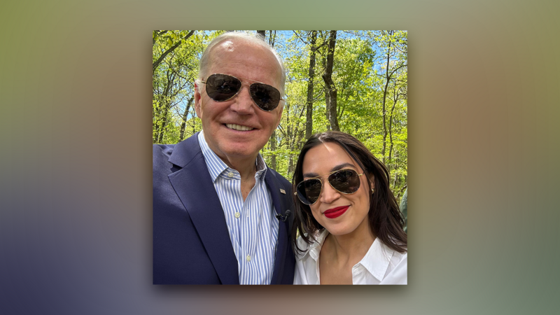 Man and woman pose together in sunglasses against a backdrop of trees