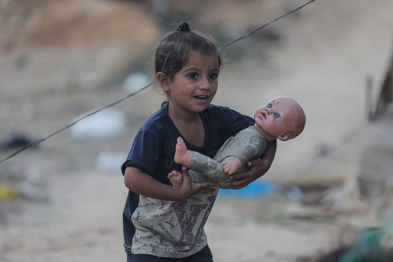 A child holds a doll 