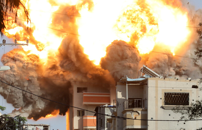 A fireball rises over a building