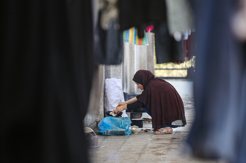 A woman washes clothes by hand