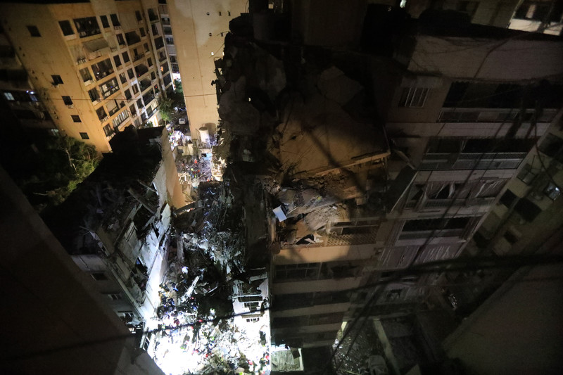 Aerial view of collapsed multi-story building at night