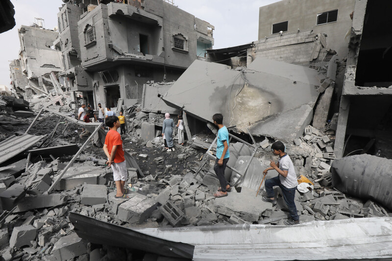 People inspect damage to homes in Gaza