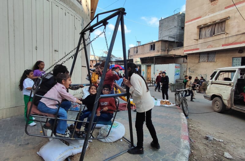 Children play on a swing