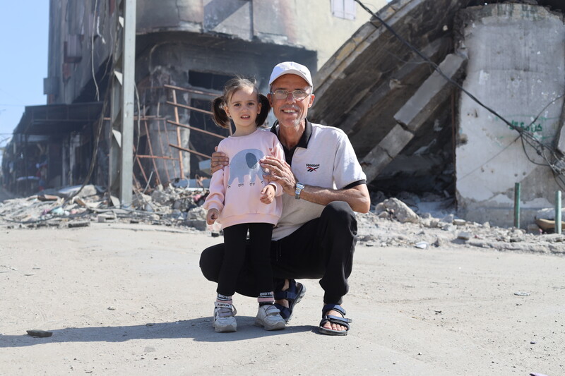 A man poses with a young girl