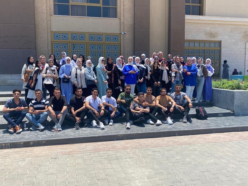 A group of students pose on the steps of a building